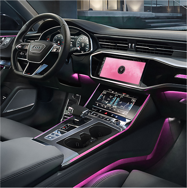 Audi cockpit with dual touchscreens and pink ambient lighting; center display shows a pink theme. 