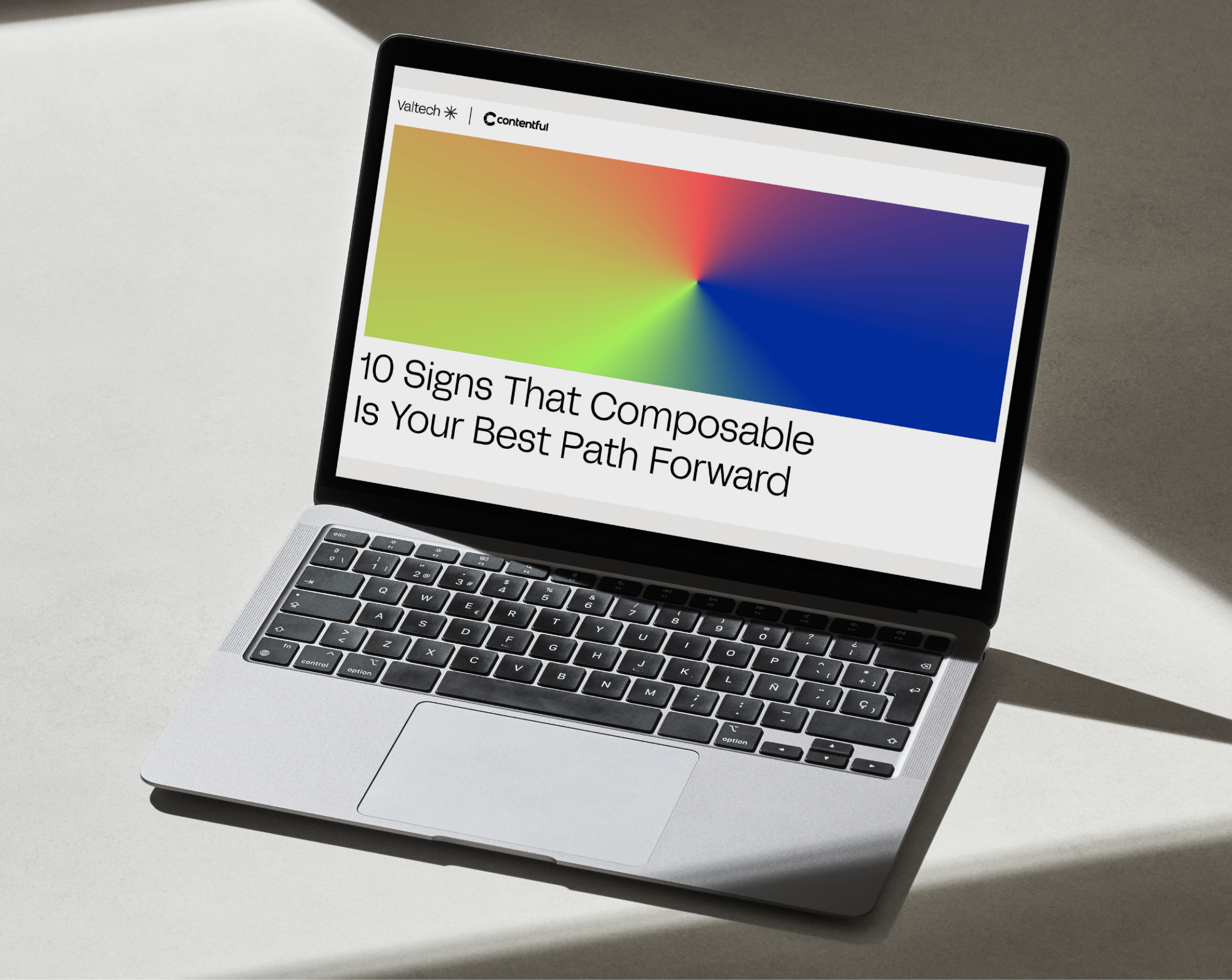 Laptop displaying Valtech and Contentful guide titled '10 Signs That Composable Is Your Best Path Forward